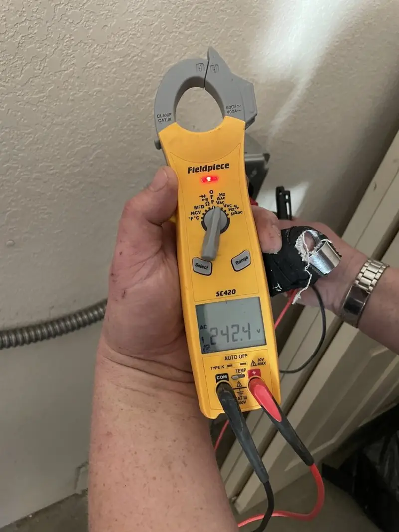 Voltage testing with clamp meter during Electrical Installation Services in West Slope